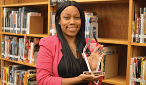 Shareefah Mason holding an award